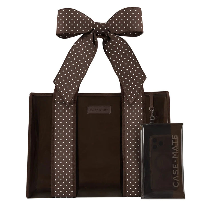 A brown tote bag with white polka-dot handles and a matching clear phone case with a large bow, both branded CASE-MATE, shown on a plain white background.
