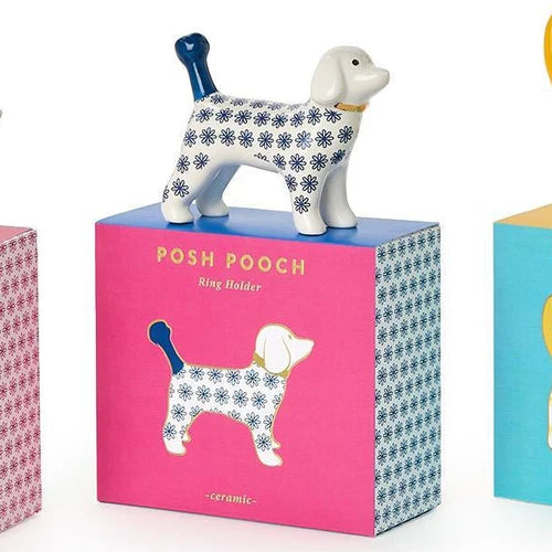 Dog-shaped ring holder on a pink box with &