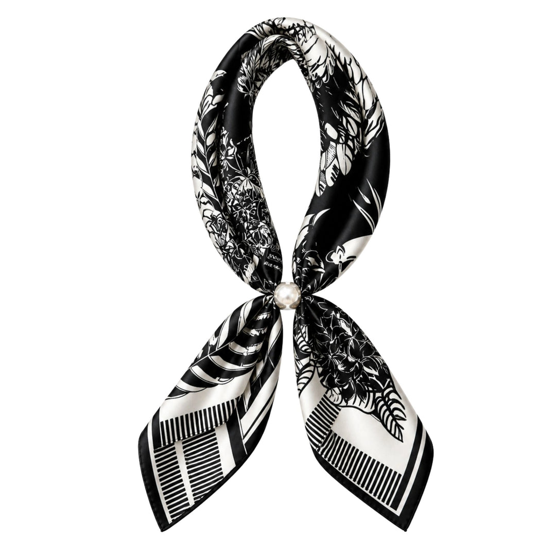 Black and white patterned scarf with a pearl brooch on a white background