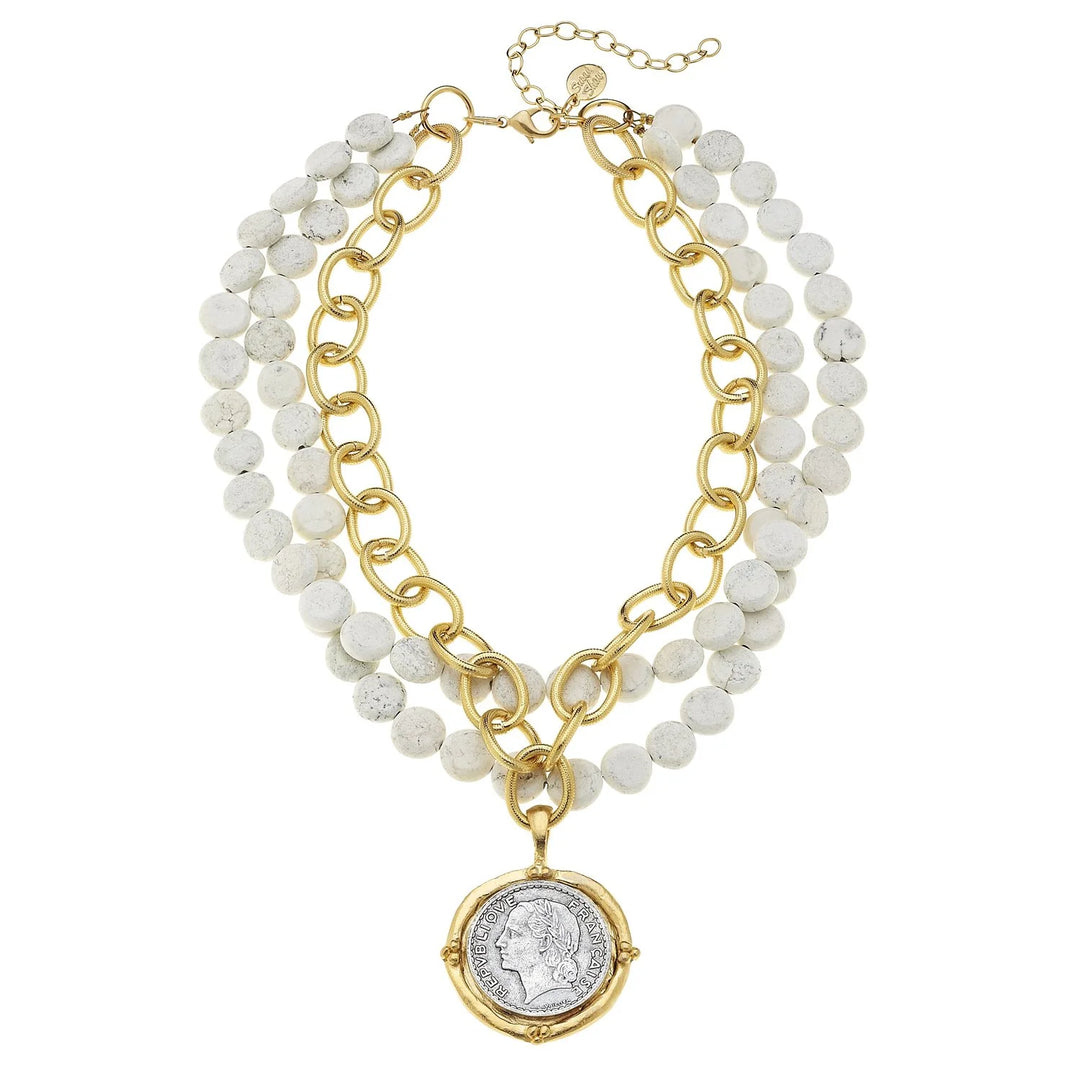 Necklace with gold chain and white beads on a white background