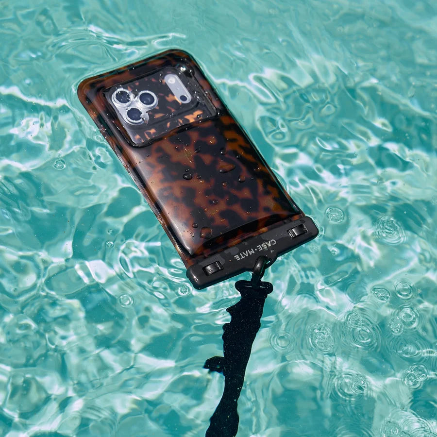Phone with tortoiseshell case and underwater housing in clear blue water