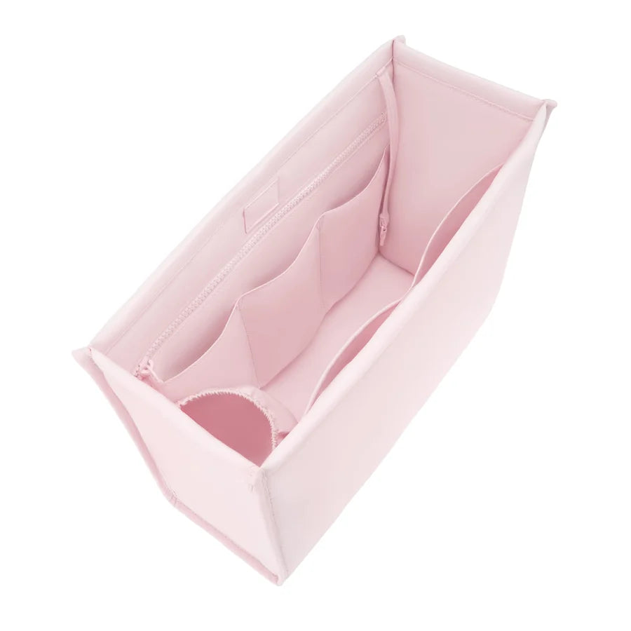 A light pink fabric organizer insert with multiple zippered compartments, shown from an elevated angle on a solid white background.