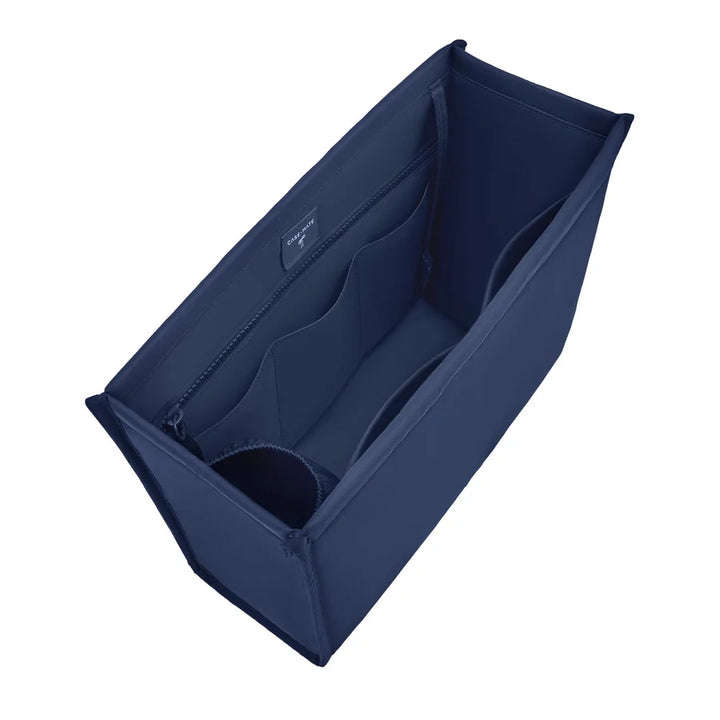 A navy blue fabric organizer insert with multiple internal compartments, shown from an elevated angle on a solid white background.