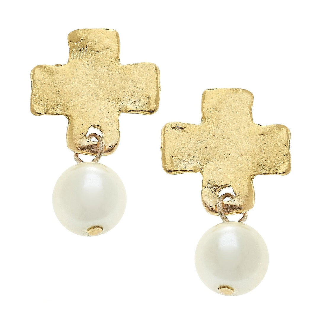 Gold cross-shaped earrings with white spherical beads on a white background