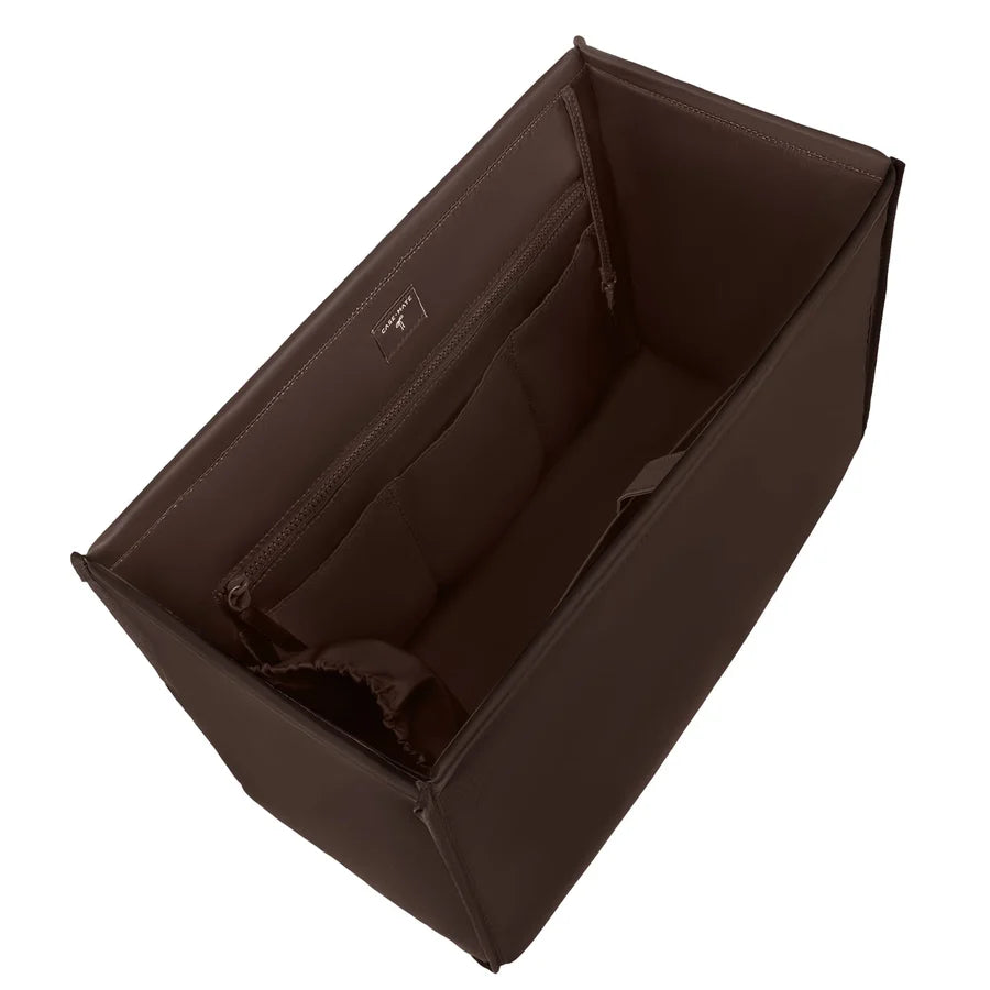 A dark brown structured diaper bag organizer insert shown from an elevated angle, featuring interior zippered compartments, on a solid white background.
