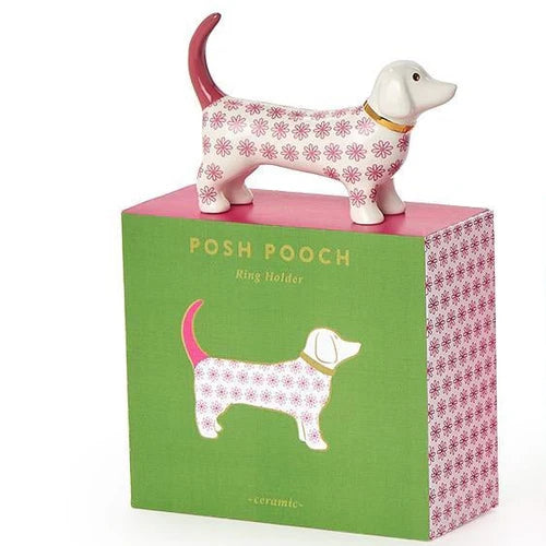 Dog-shaped ring holder on a green box with &