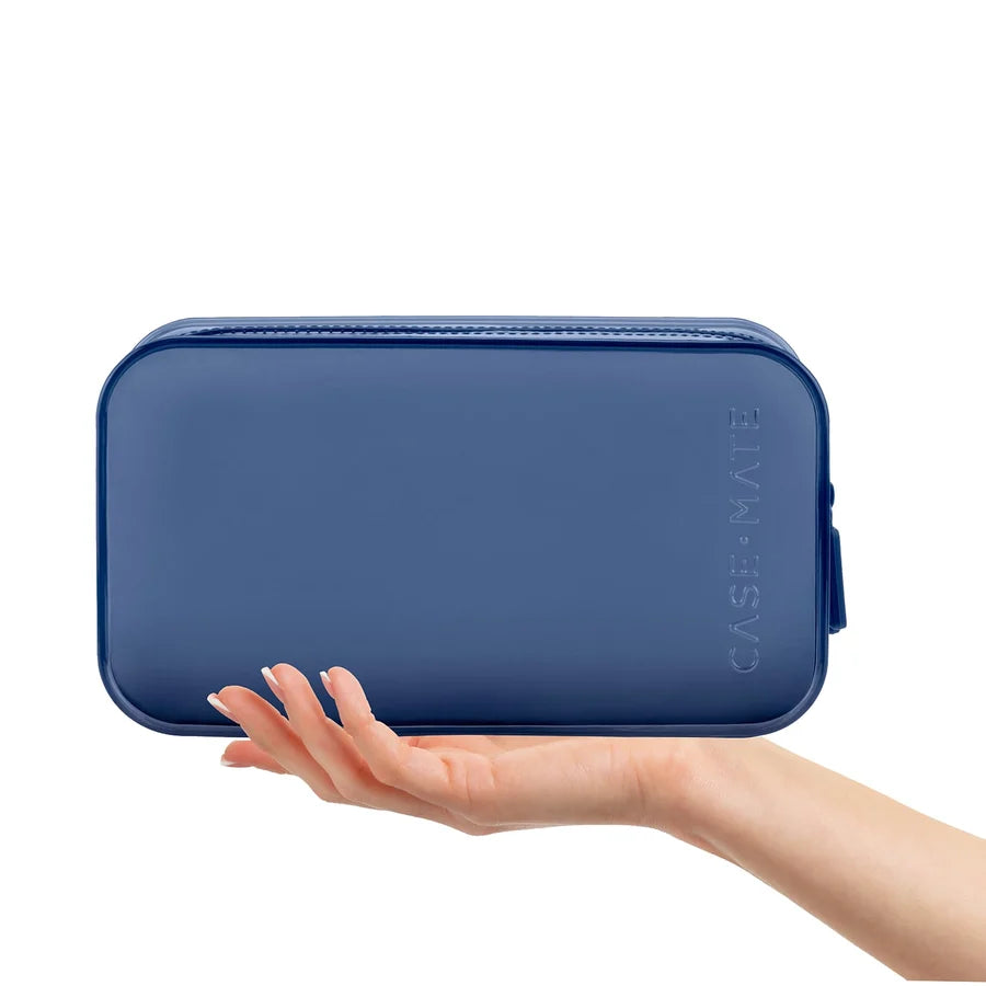 A navy blue zippered pouch held in a person&