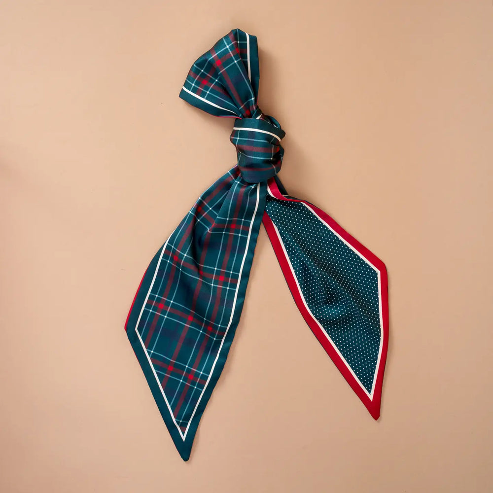 Plaid scarf tied into a bow on a beige background