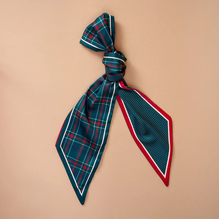 Plaid scarf tied into a bow on a beige background