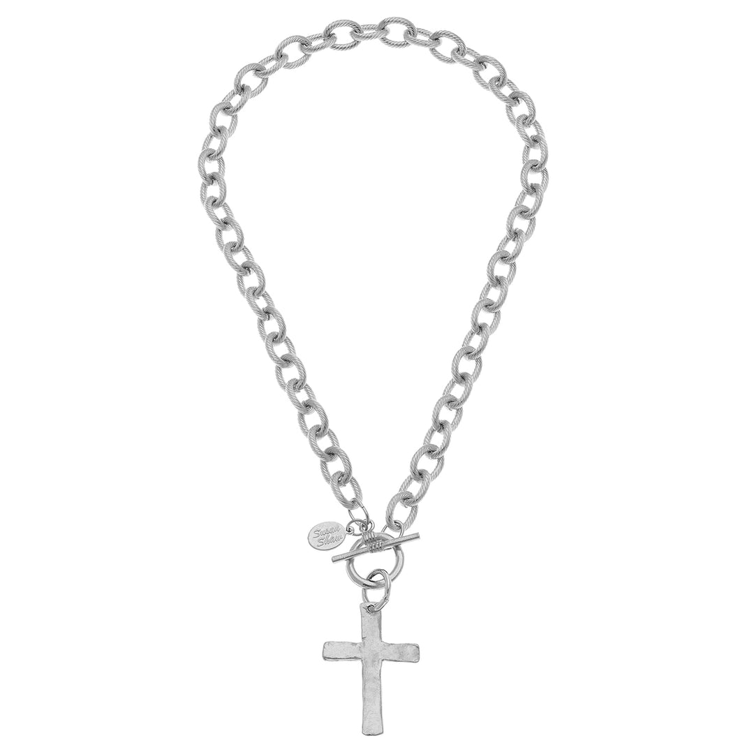 Silver chain bracelet with a cross pendant on a white background