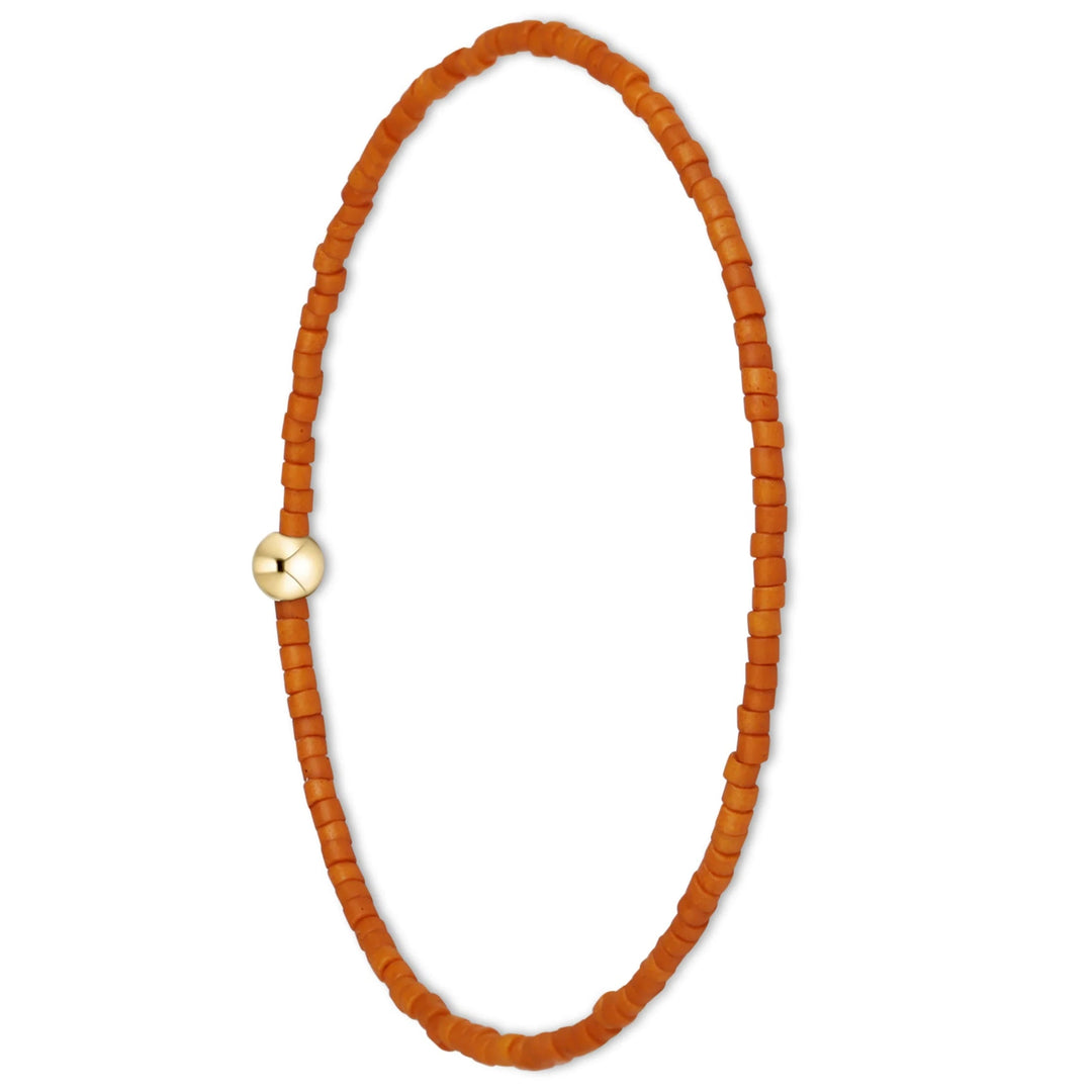 A beaded stretch bracelet made of small, warm orange-brown square beads, featuring a single polished gold-toned round bead at the closure, shown on a plain white background.
