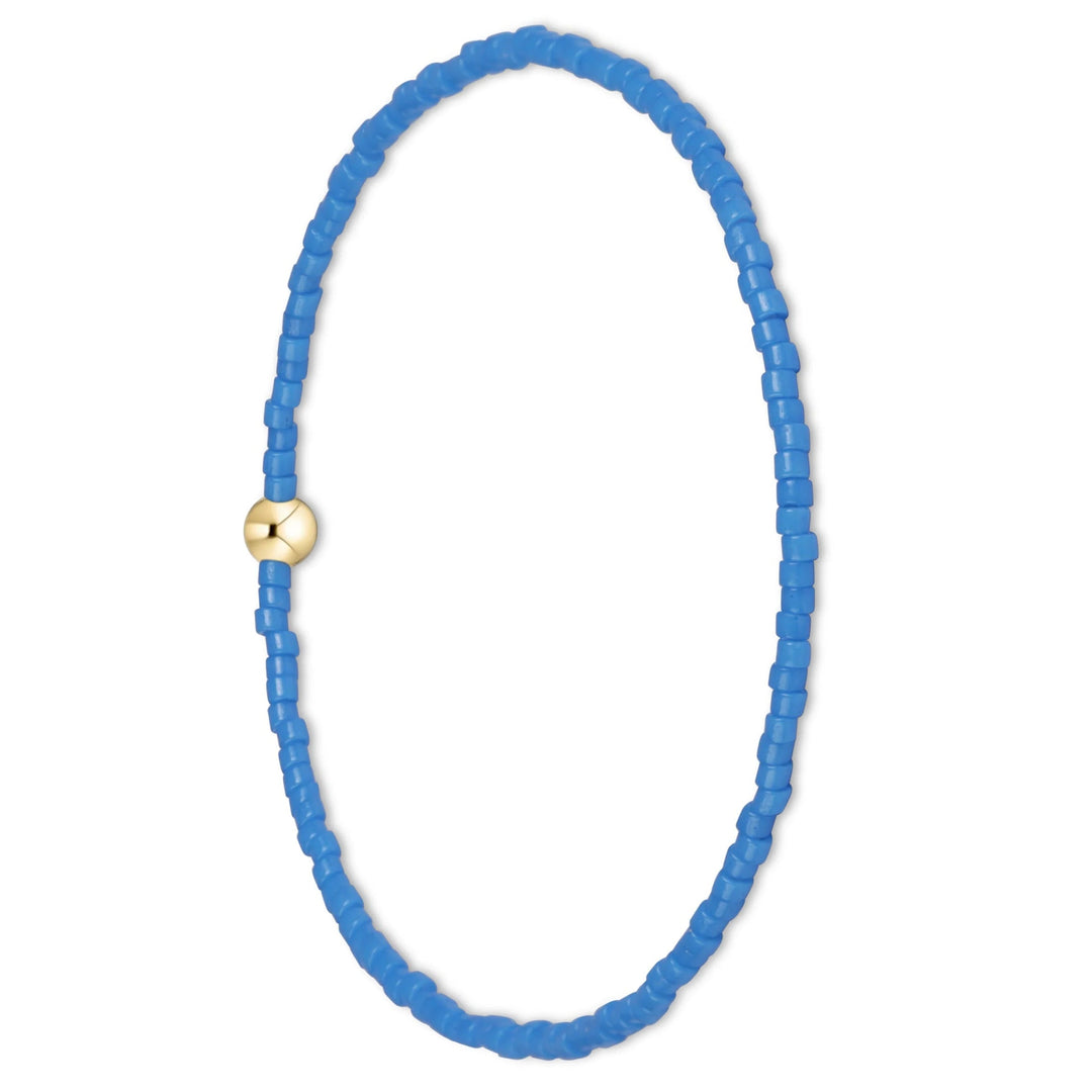 A beaded stretch bracelet featuring bright blue cylindrical beads and a small gold-toned sliding clasp, shown on a plain white background.