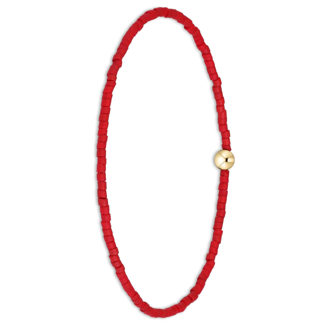 A red beaded bracelet with a small gold-toned circular clasp, displayed on a clean white background.