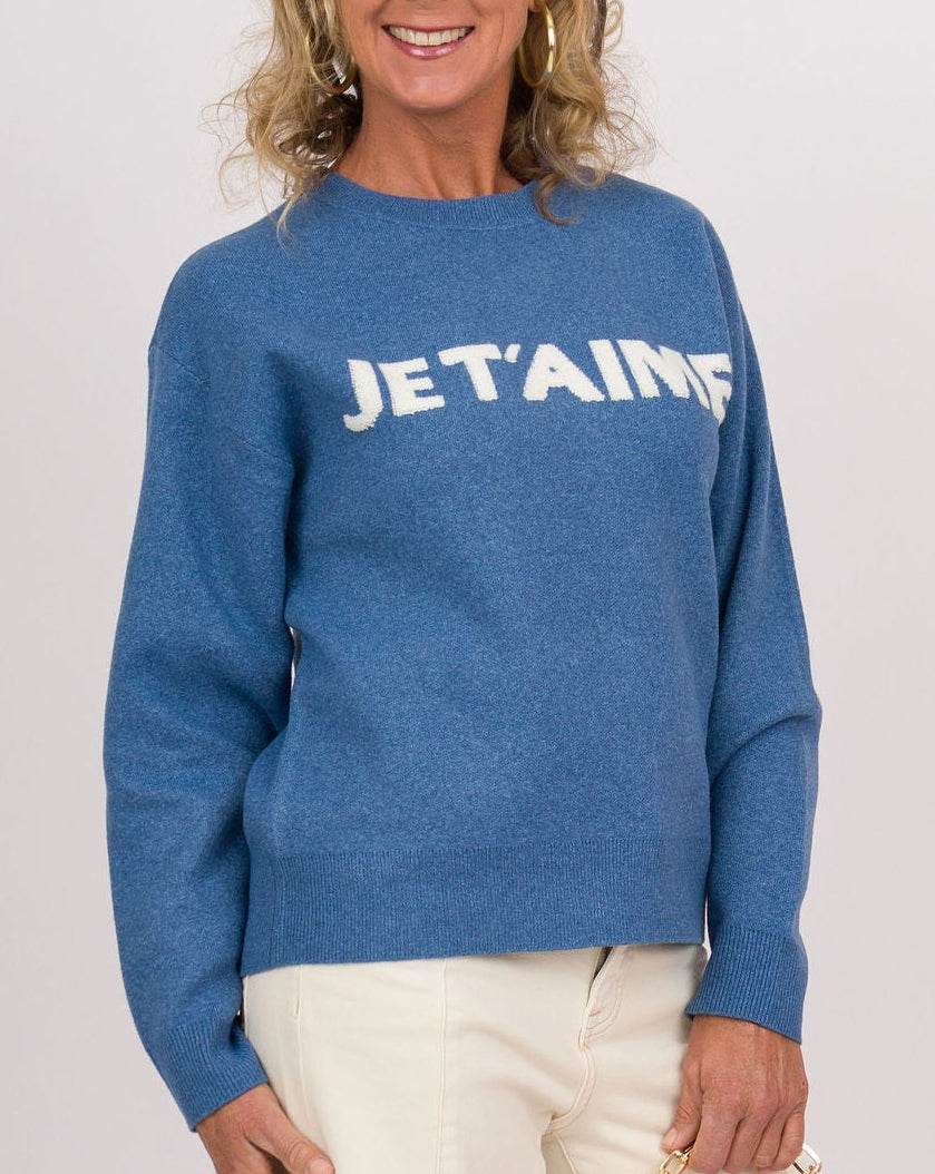 A woman modeling a blue crewneck sweatshirt with &