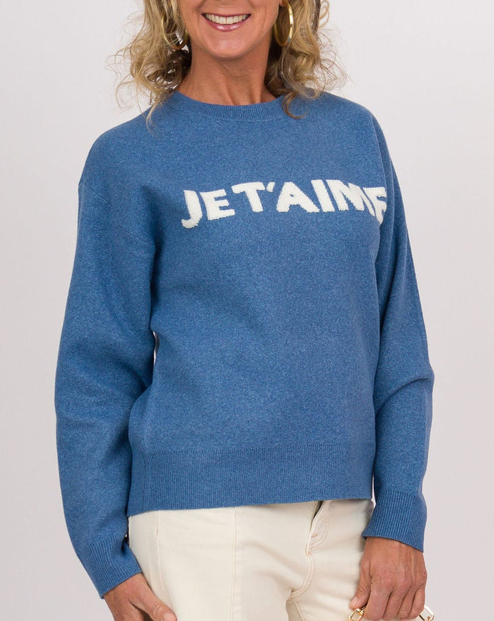 A woman modeling a blue crewneck sweatshirt with &