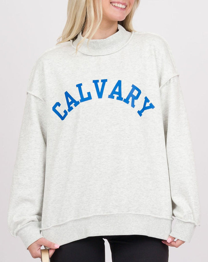 A woman modeling an oversized light gray sweatshirt with &