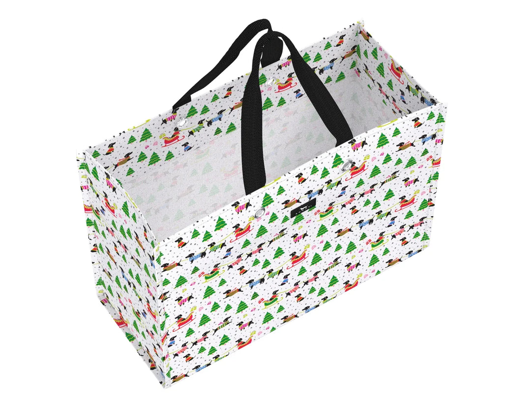 A rectangular fabric storage basket with black handles, featuring a white background printed with a colorful Christmas pattern of green trees, red ornaments, and Santa Claus sleighs.