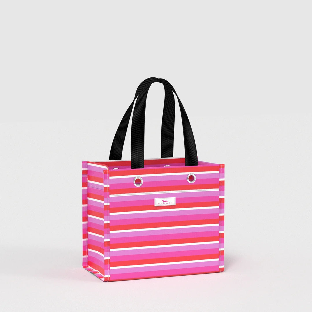 A striped tote bag with horizontal pink, magenta, and white stripes, featuring black shoulder straps and a small white logo plaque on the front, set against a plain light gray background.