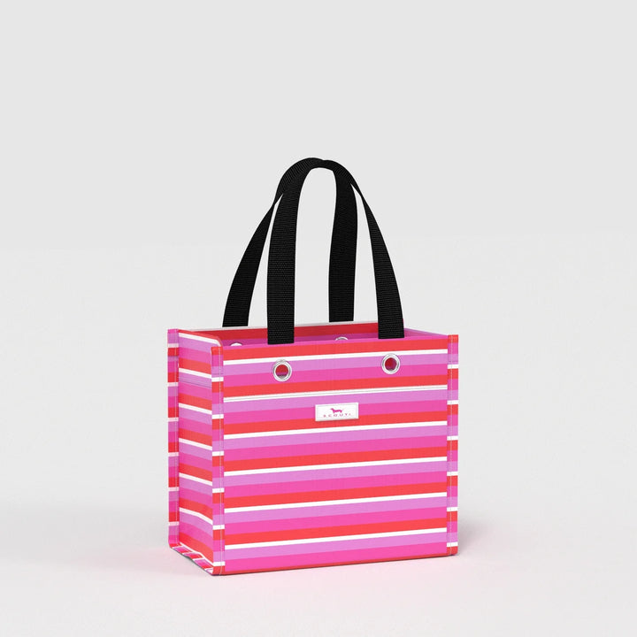 A striped tote bag with horizontal pink, magenta, and white stripes, featuring black shoulder straps and a small white logo plaque on the front, set against a plain light gray background.