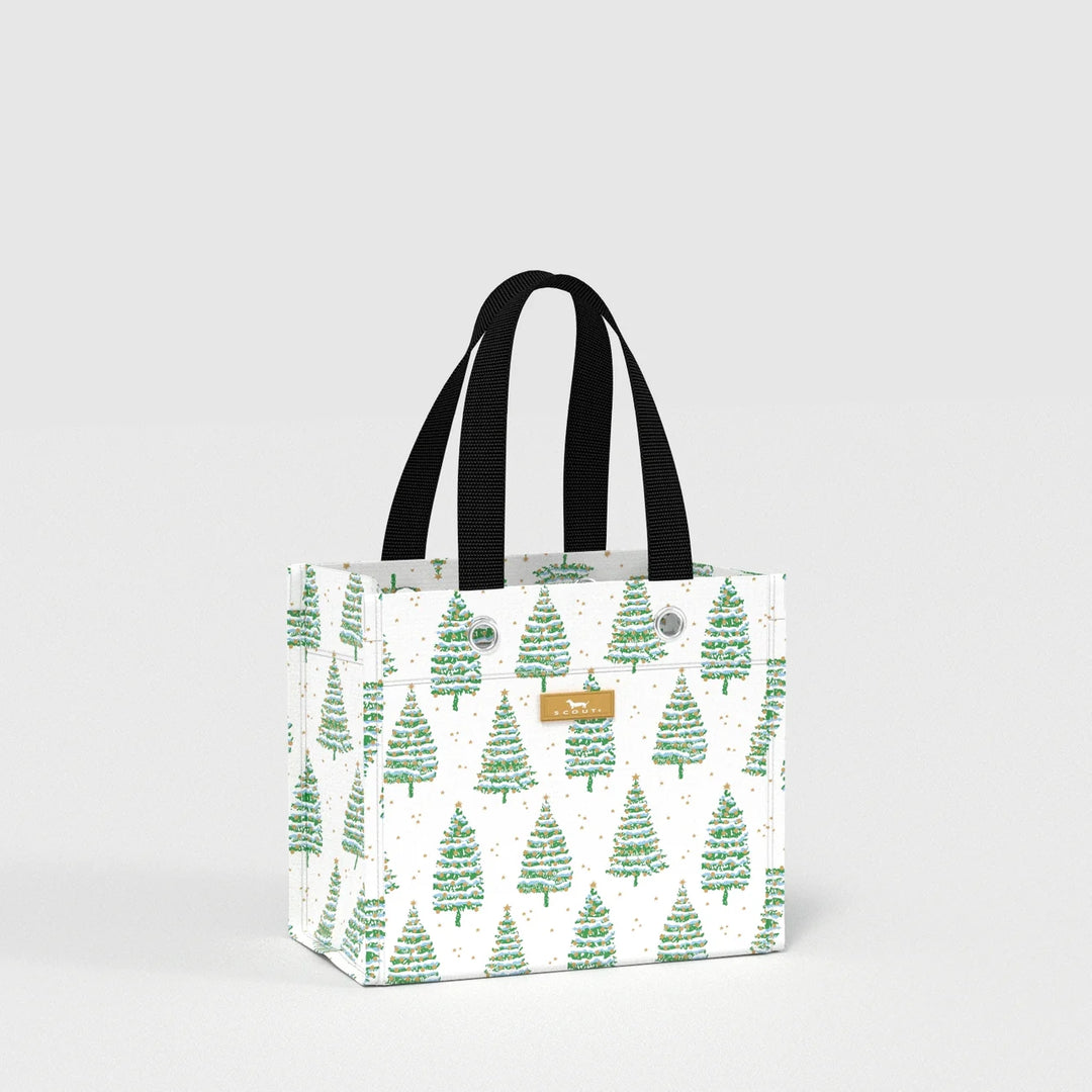 A white canvas tote bag with a green Christmas tree pattern, featuring black fabric shoulder straps and a small tan leather brand patch on the front.