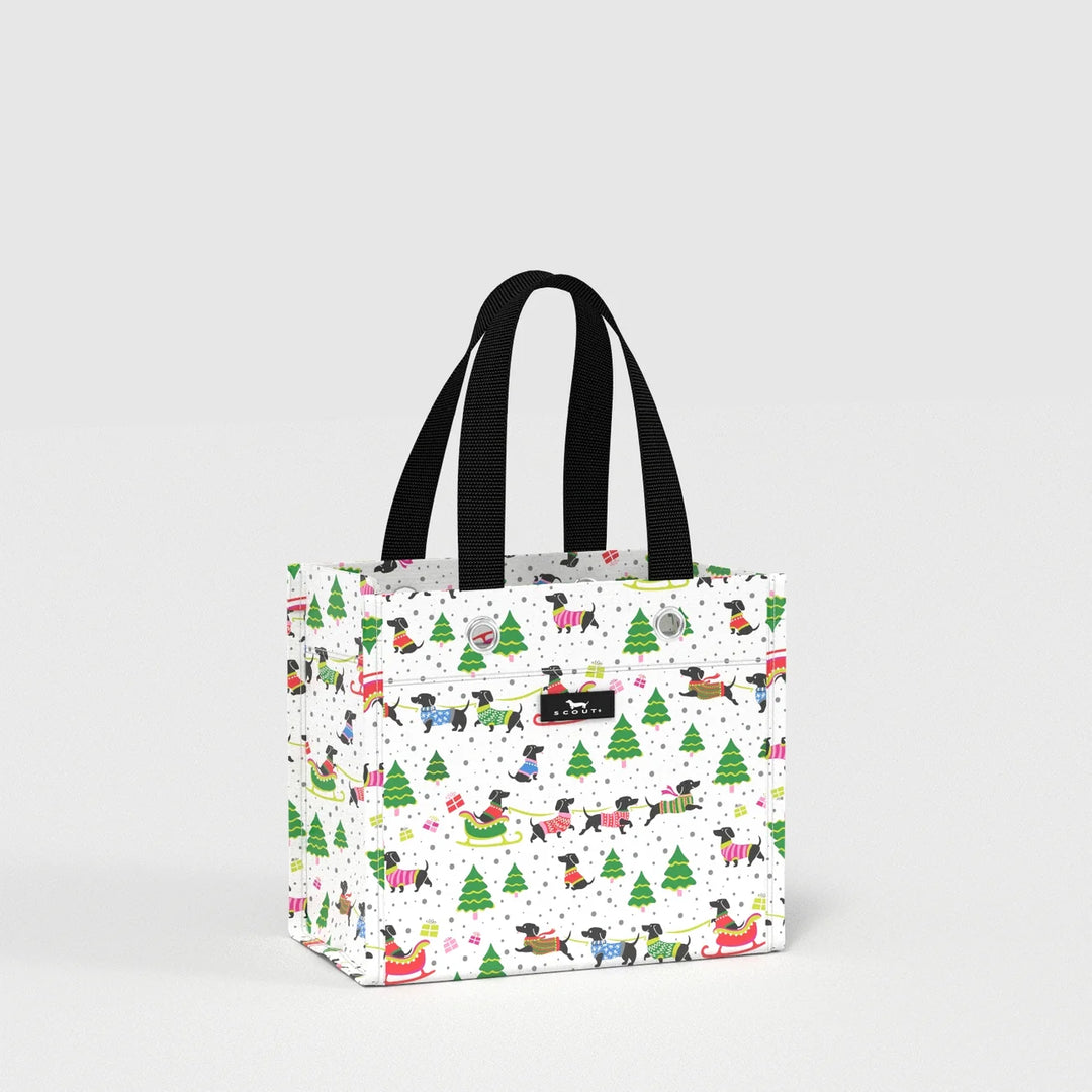 A white canvas tote bag with black handles, featuring a festive Christmas dog print with Santa, sleighs, and Christmas trees, shown on a light gray background.