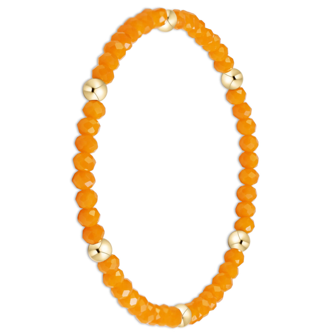 An orange faceted bead stretch bracelet with alternating polished gold metal beads, shown on a clean white background.