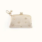 Beige clutch bag with decorative elements on a white background