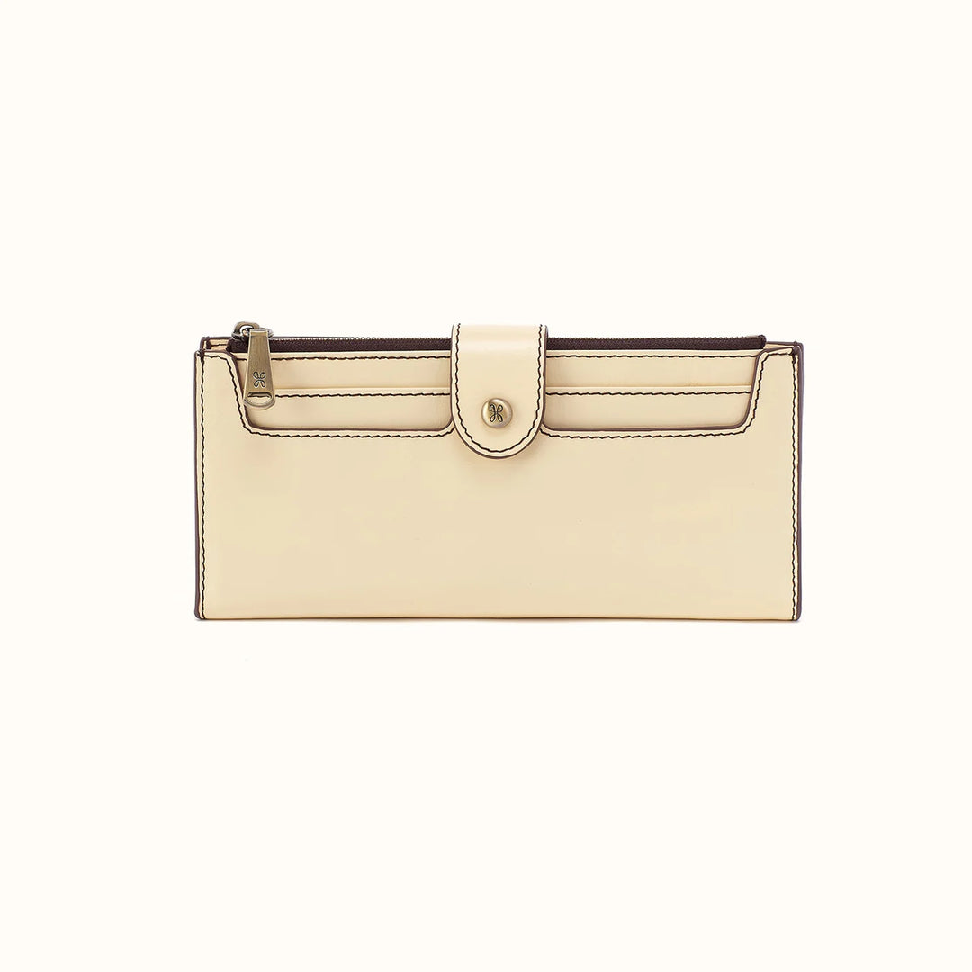 A cream-colored leather clutch wallet with a front flap closure and a gold-tone snap button, shown against a plain white background.