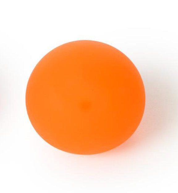 A smooth, matte orange sphere, likely a silicone or rubber massage ball, photographed from directly above on a clean white background.