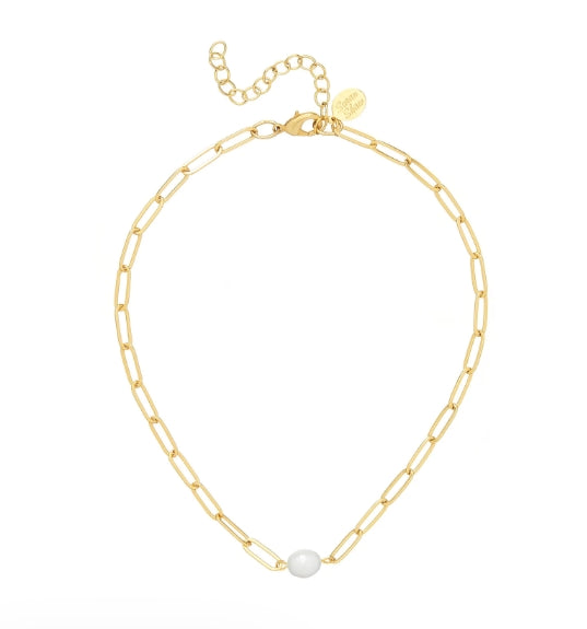 A gold paperclip chain necklace with a single white pearl at the center, displayed on a clean white background.