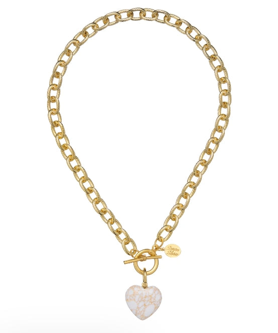 A gold chain necklace with a toggle clasp and a heart-shaped pendant featuring a white and gold marbled pattern, shown on a plain white background.