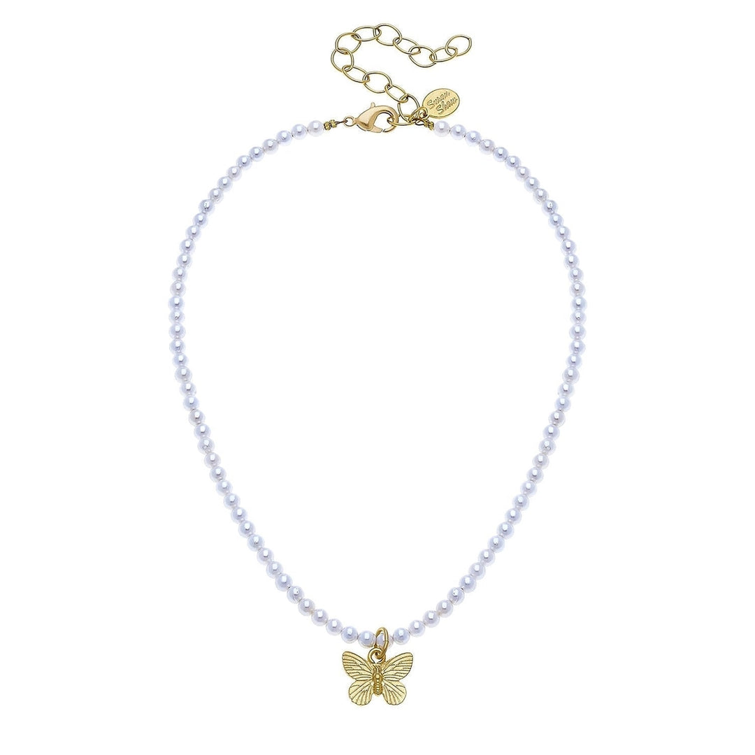 Pearl necklace with gold butterfly charm on a white background