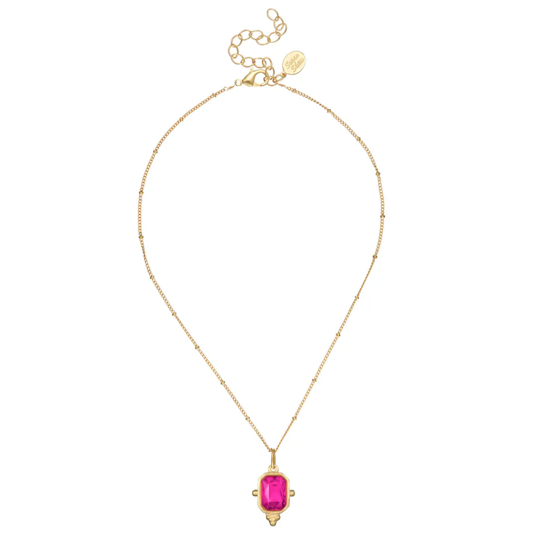 A gold chain necklace featuring a rectangular pink gemstone pendant with a decorative gold border, displayed on a clean white background.