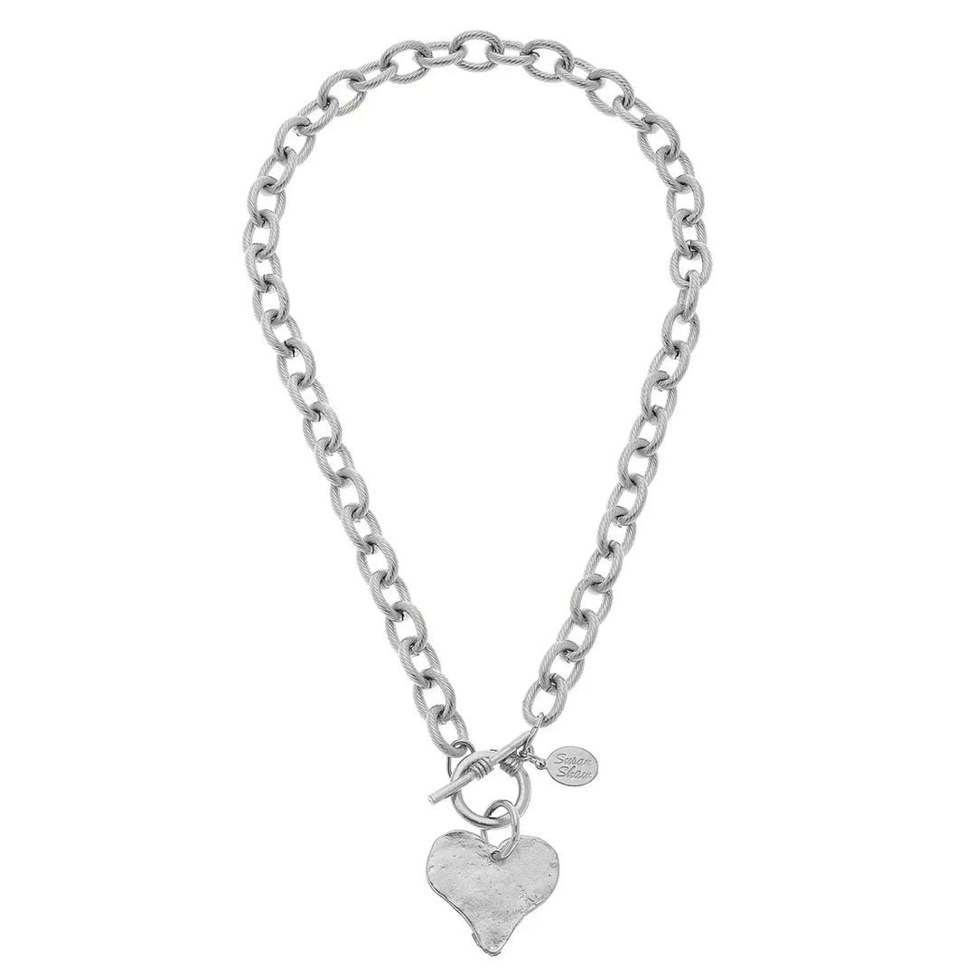Silver chain bracelet with a heart-shaped charm on a white background
