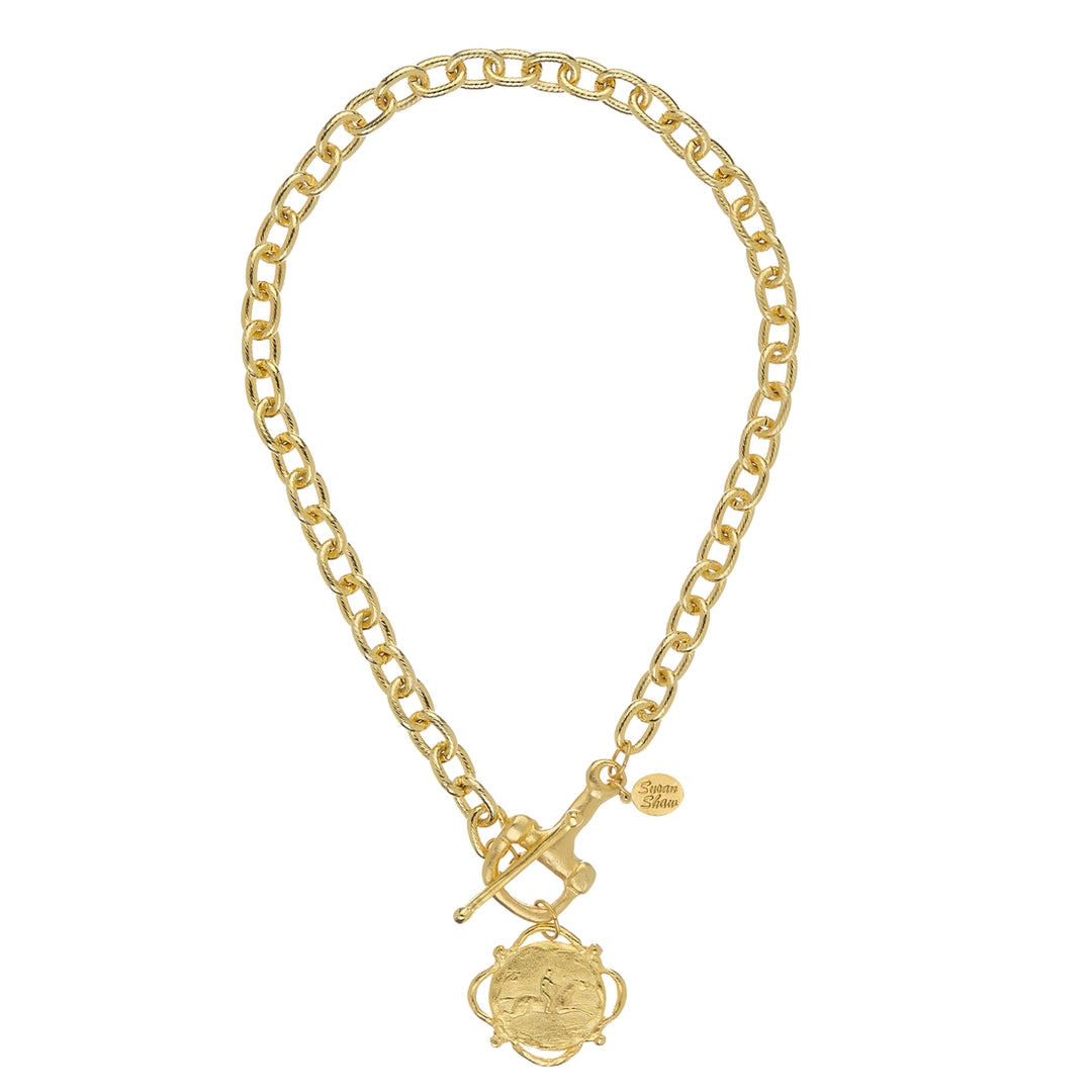 Gold chain necklace with a pendant on a white background
